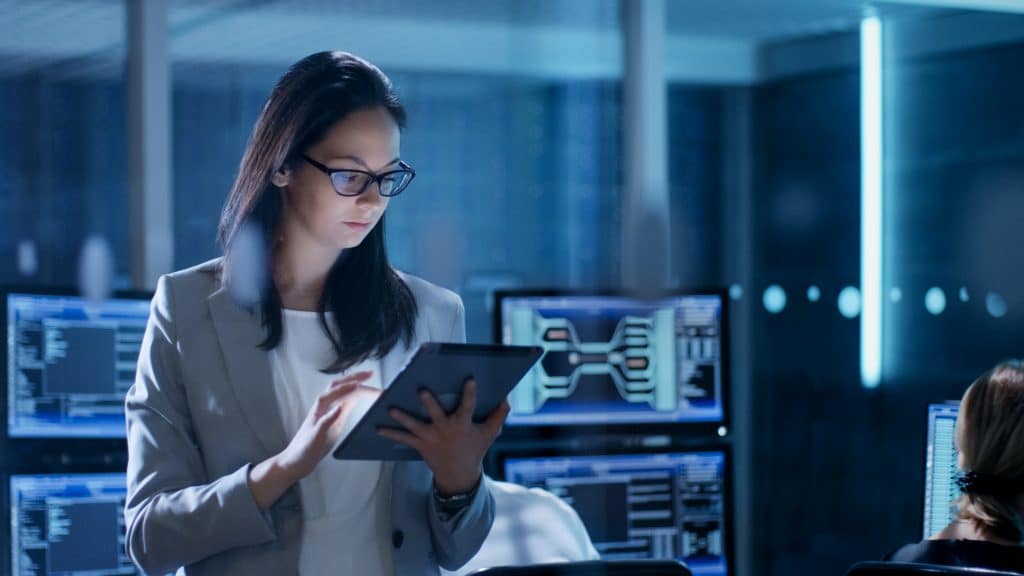 Government employee uses tablet in system control center.