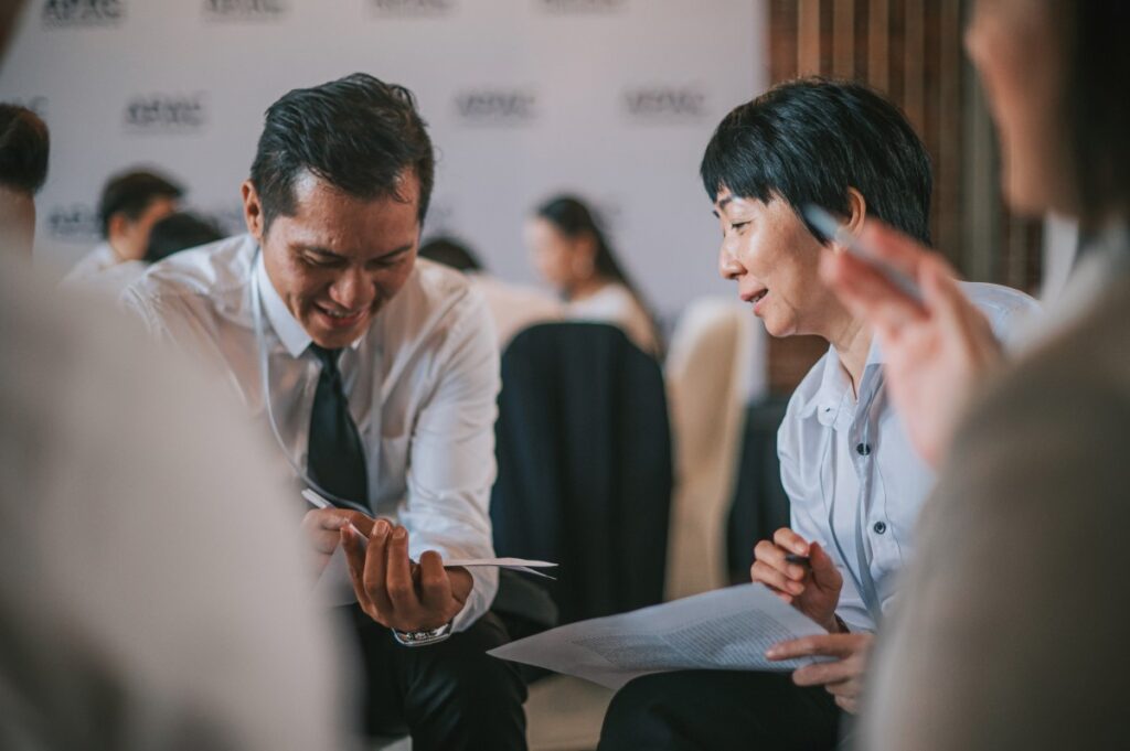 Business workshop participants in a small group discussion.