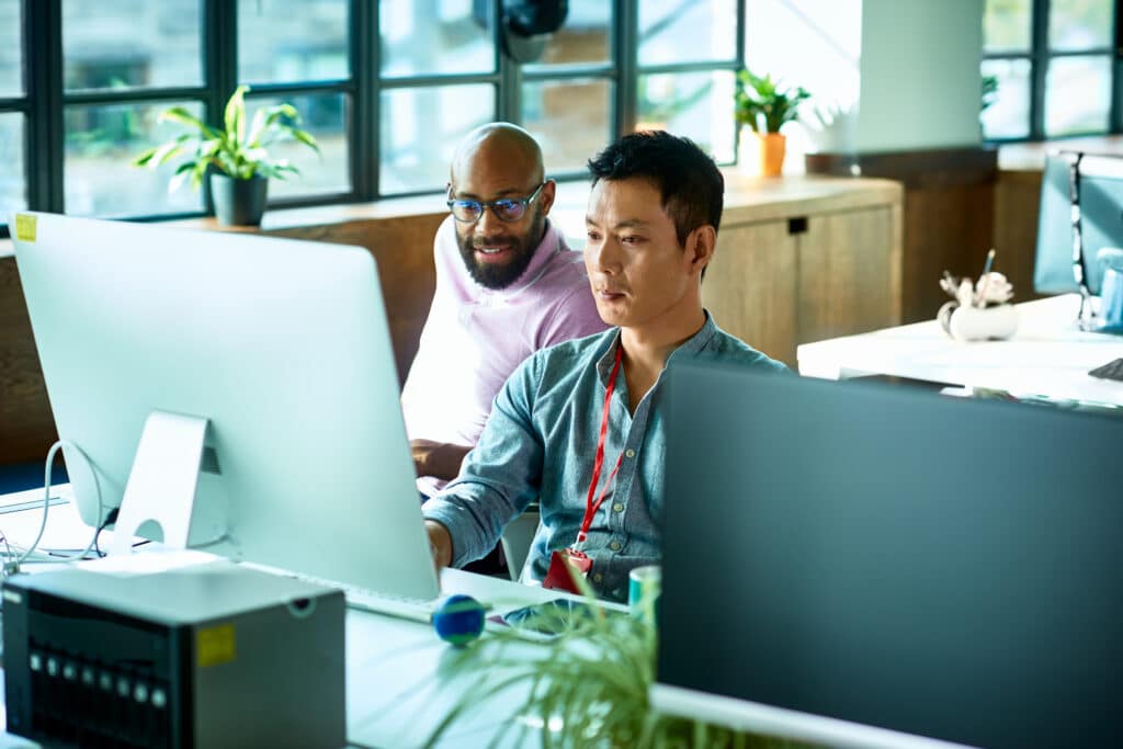 Two colleagues collaborating at a desk.